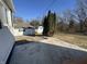 Backyard showing a concrete patio area, shed, and trees under a clear blue sky at 1509 S Hawthorne Ln, Indianapolis, IN 46203