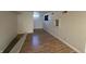 This basement room features hardwood-style floors, and white walls at 1509 S Hawthorne Ln, Indianapolis, IN 46203