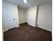 This basement room features hardwood-style floors, white walls and an access door at 1509 S Hawthorne Ln, Indianapolis, IN 46203