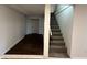 Basement view with staircase and vinyl floors showing the potential living space at 1509 S Hawthorne Ln, Indianapolis, IN 46203