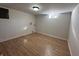 Unfinished basement area with vinyl flooring, and light ready for your custom design at 1509 S Hawthorne Ln, Indianapolis, IN 46203