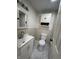 This bathroom features a sink vanity, toilet, and tiled floors at 1509 S Hawthorne Ln, Indianapolis, IN 46203