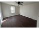 This bedroom features hardwood-style floors, a window and light colored walls at 1509 S Hawthorne Ln, Indianapolis, IN 46203