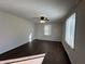 Bright bedroom with a ceiling fan, natural light from a window, and warm wood-look flooring at 1509 S Hawthorne Ln, Indianapolis, IN 46203