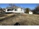 Charming one-story house featuring white siding, a covered porch, and a green roof, situated on a well-maintained lawn at 1509 S Hawthorne Ln, Indianapolis, IN 46203