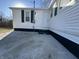 Home exterior featuring concrete slab, siding and window shutters under clear blue sky at 1509 S Hawthorne Ln, Indianapolis, IN 46203