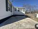 Home exterior showing a concrete patio, siding, window shutters and rear entrance at 1509 S Hawthorne Ln, Indianapolis, IN 46203