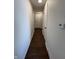 Clean hallway with smooth walls, wood-look floors, and doors leading to various rooms at 1509 S Hawthorne Ln, Indianapolis, IN 46203