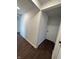 Clean hallway featuring clean, white walls and modern wood-look flooring at 1509 S Hawthorne Ln, Indianapolis, IN 46203
