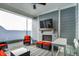 Covered back patio showcasing a fireplace, outdoor seating, and a ceiling fan for relaxation at 15297 Fairlands Dr, Westfield, IN 46074