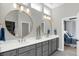 Bright bathroom with double sinks, gold framed circular mirrors, and an ensuite bedroom at 15297 Fairlands Dr, Westfield, IN 46074