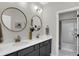 Modern bathroom with double vanity, round mirrors, and a separate shower/tub area at 15297 Fairlands Dr, Westfield, IN 46074
