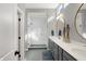 Elegant bathroom featuring a double sink vanity, modern light fixtures, and a glass-enclosed shower at 15297 Fairlands Dr, Westfield, IN 46074