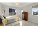 Bright bedroom featuring light gray walls, two windows, carpeted floor, and yellow/gray bedding at 15297 Fairlands Dr, Westfield, IN 46074