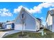Side angle of house with blue siding, white garage door, and a well-maintained lawn at 15297 Fairlands Dr, Westfield, IN 46074