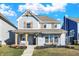 Charming two-story home with a light blue exterior, decorative shutters, and a welcoming front porch at 15297 Fairlands Dr, Westfield, IN 46074