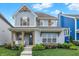 Charming two-story home featuring a welcoming front porch, beautiful landscaping, and a well-manicured lawn at 15297 Fairlands Dr, Westfield, IN 46074