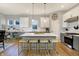 Spacious kitchen boasting a large center island, white cabinetry, stainless steel appliances, and designer lighting at 15297 Fairlands Dr, Westfield, IN 46074