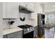 Close-up of the kitchen features a stainless steel range, white cabinetry, and modern appliances for culinary enthusiasts at 15297 Fairlands Dr, Westfield, IN 46074
