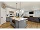 Open kitchen features a large center island with built-in microwave, stainless appliances, and seamless flow to the living room at 15297 Fairlands Dr, Westfield, IN 46074