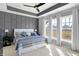 Serene main bedroom with a decorative accent wall, tray ceilings, ample natural light, and a ceiling fan at 15297 Fairlands Dr, Westfield, IN 46074