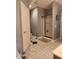 Bathroom with white door, tile floors, shower stall, and commode at 16 Torrey Pine Dr, Brownsburg, IN 46112