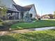 A beautifully landscaped lawn and outdoor patio area complement the exterior of this two-story brick home at 16 Torrey Pine Dr, Brownsburg, IN 46112