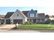 Charming brick and siding two-story home featuring a manicured front lawn and attached two-car garage at 16 Torrey Pine Dr, Brownsburg, IN 46112