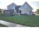 Beautifully landscaped backyard featuring a covered patio area, mature trees, and lush green grass at 16 Torrey Pine Dr, Brownsburg, IN 46112