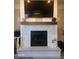 Living room fireplace with modern design elements, mantle, and stone hearth at 16 Torrey Pine Dr, Brownsburg, IN 46112