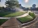 The landscaped front yard of a home is watered by sprinklers on a bright, sunny day in this neighborhood at 16 Torrey Pine Dr, Brownsburg, IN 46112