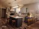 Well-lit kitchen featuring an island with seating, tiled backsplash, modern lighting, and ample countertop space at 16 Torrey Pine Dr, Brownsburg, IN 46112