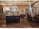 Open kitchen with a large island, modern lighting, tile backsplash, and an adjacent dining area at 16 Torrey Pine Dr, Brownsburg, IN 46112