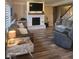 Spacious living room with a fireplace, hardwood floors, neutral paint colors, and comfortable seating arrangements at 16 Torrey Pine Dr, Brownsburg, IN 46112