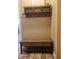 Mudroom featuring a wooden bench and shelf with hooks for organization in the front entry at 16 Torrey Pine Dr, Brownsburg, IN 46112