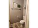 Stylish powder room with decorative wall art and wood-look vinyl floors at 16 Torrey Pine Dr, Brownsburg, IN 46112