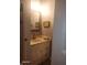 Clean powder room with a white vanity, marble-look countertop, and a gold-framed mirror at 16 Torrey Pine Dr, Brownsburg, IN 46112