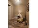 Small sitting area with chair, ottoman, wood floors, and lighting at 16 Torrey Pine Dr, Brownsburg, IN 46112