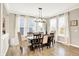Bright dining room with large windows, a dark wood dining table, and neutral-toned decor that creates a comfortable space at 16808 Audley Ave, Westfield, IN 46074