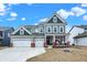 Charming two-story home featuring a three-car garage, a welcoming porch, and a well-maintained lawn at 16808 Audley Ave, Westfield, IN 46074