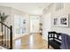 Bright foyer with wood floors, white trim, and a bench creating a warm and inviting atmosphere at 16808 Audley Ave, Westfield, IN 46074