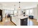 Bright kitchen featuring a large island with seating, stainless steel appliances, and an open floor plan at 16808 Audley Ave, Westfield, IN 46074