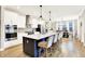 Modern kitchen with stainless steel appliances, a large island, and stylish pendant lighting at 16808 Audley Ave, Westfield, IN 46074