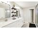 Bright bathroom featuring a double vanity, modern mirrors, stylish decor, and a glass-enclosed shower at 16808 Audley Ave, Westfield, IN 46074