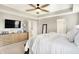 Serene main bedroom with a plush bed, a ceiling fan, a large dresser, and soft lighting that enhances the room's ambiance at 16808 Audley Ave, Westfield, IN 46074