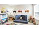 Bright playroom showcasing a modular blue sofa, learning center, and playful decor at 16808 Audley Ave, Westfield, IN 46074