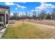 Brick home with a covered patio and spacious lawn with neighborhood street view at 1684 Hedley W Way, Avon, IN 46123