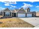 Charming brick home with a three-car garage and well-maintained lawn under a sunny sky at 1684 Hedley W Way, Avon, IN 46123