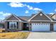 Charming brick home with attached two car garage, neat landscaping, and classic architectural details at 1684 Hedley W Way, Avon, IN 46123