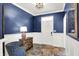 Stylish foyer with wainscoting, hardwood floors, and a decorative table, creating an inviting entrance at 1684 Hedley W Way, Avon, IN 46123